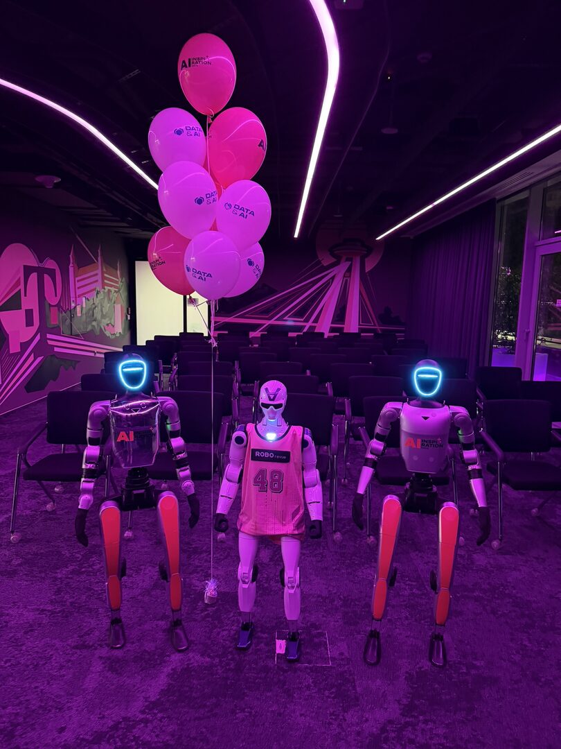 Three humanoids in T-Mobile shirts before the opening